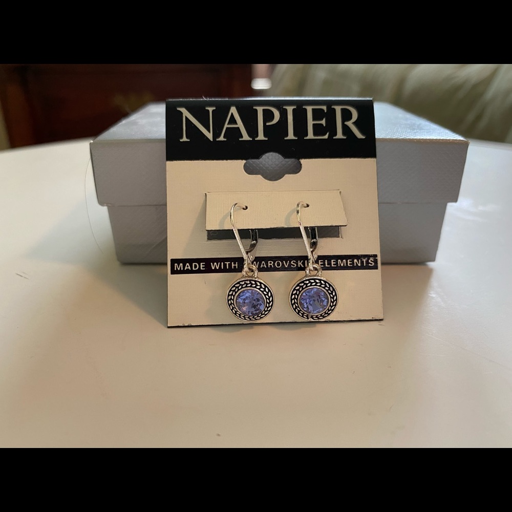 Silver colored dangle earrings with purple stone